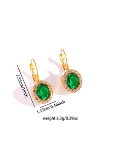 Detailed view of vintage gold earrings with green emerald stone and diamond halo size specs
