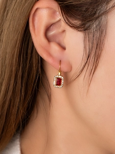Macro view of 18K gold plated lever-back earrings with rectangle red ruby and zircon