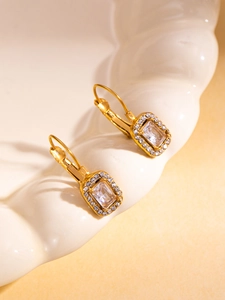 Close-up of gold leverback earrings with emerald-cut crystals and sparkling halo