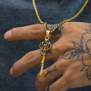 Gothic crown key pendant necklace in gold-finished steel worn on neck for men and women