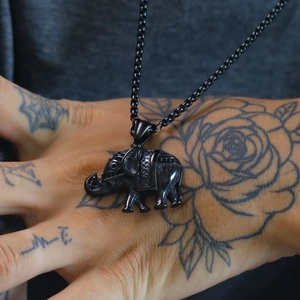 Retro punk black elephant pendant necklace in stainless steel on tattooed hand background