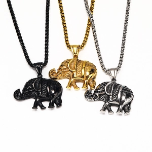 Detailed view of vintage elephant pendants in black, gold and antique silver finishes