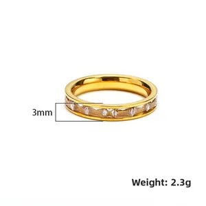 Macro detail of 3mm wide gold plated titanium steel ring with rectangular zircons