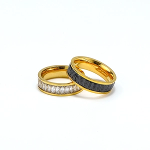 Close-up of titanium steel rings with black and white marquise-cut cubic zirconia crystals