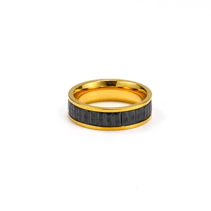 Macro shot of polished gold ring featuring rectangular black gemstone step-cut inlay