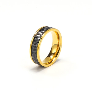 Macro shot of titanium steel ring with Clou de Paris pattern and gold polished edges