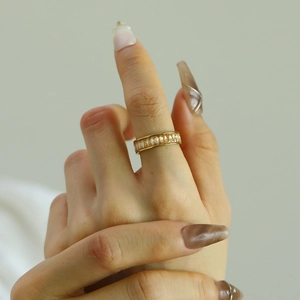 Close-up of eternity ring with champagne rectangular crystals on gold-plated band
