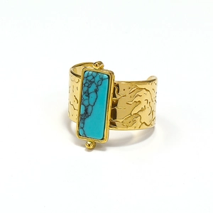 Detail of 18k gold-plated hammered wide band ring with rectangular blue turquoise stone