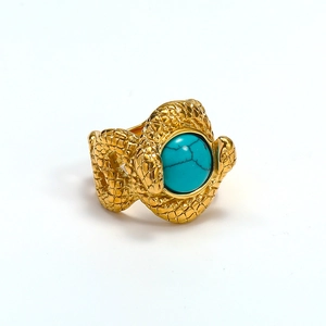 Detail of vintage snake-textured gold ring with round turquoise stone inlay