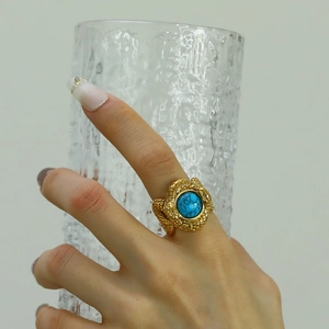 Detail of snake scale texture and turquoise stone on gold titanium steel ring