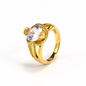 Detailed close-up of a gold-plated ring with large oval clear gemstone and textured band
