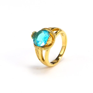 Detailed macro view of an 18k gold plated ring featuring an oval blue gemstone inlay