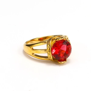 Detail of vintage 18k gold plated ring featuring a large red round-cut gemstone focal