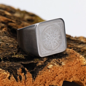 Macro detail of vintage compass engraved signet ring with brushed titanium steel finish