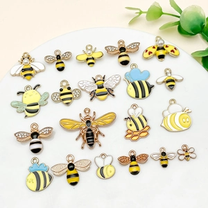 Set of twenty diverse cartoon bee alloy charms with colorful enamel and pearl details
