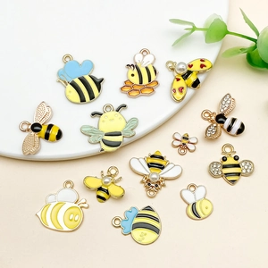 Detailed set of varied bee alloy pendants with colorful enamel drips and small pearls