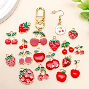 Detailed view of DIY fruit alloy pendants including strawberry, cherry, and apple charms