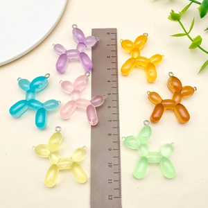 Detailed size view of colorful resin balloon dog charms for DIY jewelry making