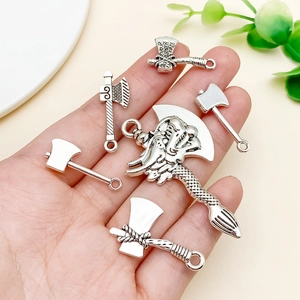 Detail of six antique silver axe pendants for DIY jewelry with intricate dragon designs