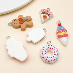Detail of assorted resin dessert charms like donuts and ice cream for DIY crafts
