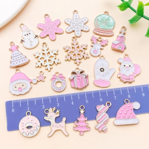 Pink enamel Christmas charms in Santa, reindeer, and snowflake designs with golden finish