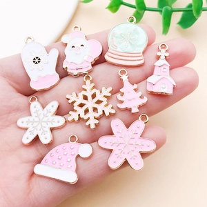 Pink Christmas alloy charms set held in palm for DIY jewelry making accessories