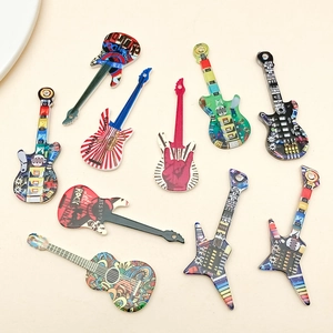 Detailed view of colorful acrylic guitar charms with rock and punk graffiti art patterns