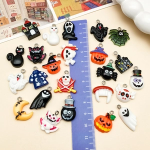 Mix of Halloween resin pendants featuring cute pumpkins and ghosts with a ruler scale
