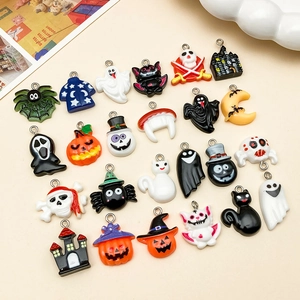 Flat lay of colorful resin Halloween charms including pumpkins, ghosts, and bats for DIY jewelry