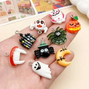 Detailed close-up of cute Halloween resin charms featuring pumpkin ghost and bat shapes