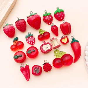 Macro shot of 3D resin red fruit and vegetable charms for DIY jewelry making