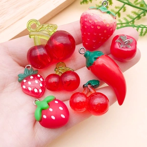 Detailed palm shot of resin 3D red fruit and vegetable charms for DIY jewelry making