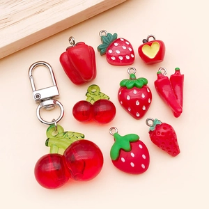 Macro view of cute resin strawberry, cherry, and pepper charms for DIY jewelry making