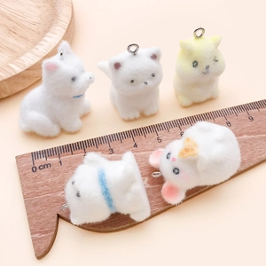 Detailed view of five mini flocked animal charms for DIY keychains with scale reference