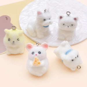 Macro shot of five flocked cartoon animal pendants with soft fur texture for DIY crafts