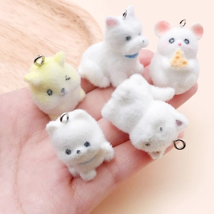 Close-up of five cute flocked animal charms featuring puppies and hamsters for DIY jewelry