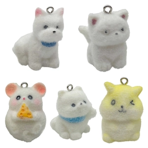 Five assorted flocked animal pendants including puppy and hamster with silver metal rings
