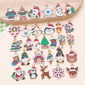 Flat lay detail of 29 colorful enamel Christmas alloy charms for DIY jewelry making