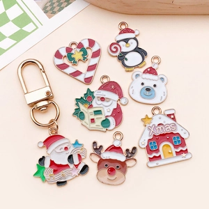 Flat lay of colorful Christmas enamel charms including Santa and reindeer for DIY jewelry