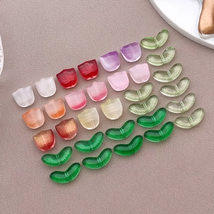 Detailed macro view of colorful tulip petal and leaf glass beads for DIY jewelry making