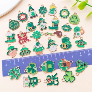 St. Patrick's Day enamel charms with clover and hat patterns shown with a blue ruler