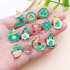 Macro detail of St. Patrick's Day enamel alloy charms with lucky clover and hat designs