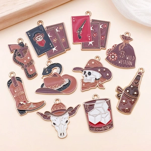 Set of 11 vintage Wild West enamel pendants featuring skulls boots and revolvers