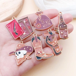 Detail of Wild West charms showing skull cowboy boots and gun pendants in a hand