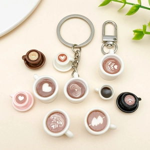 Detailed macro view of assorted miniature resin latte art coffee cup charms and pendants