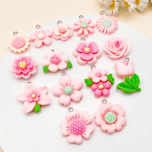 Detail of pink resin flower charms including roses and daisies for DIY jewelry making