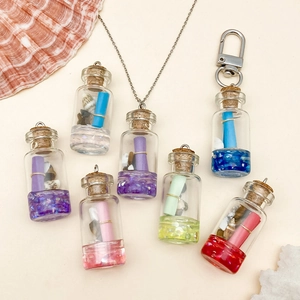 Handmade resin wishing bottle pendants with tiny shells and colorful scrolls inside