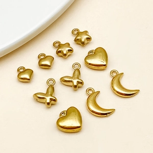 Detailed view of gold plated heart star moon and butterfly DIY jewelry pendants