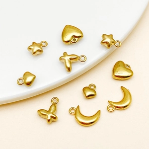 Set of gold-plated stainless steel charms including heart, star, moon, and butterfly