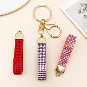 Luxury rhinestone velvet keychains in red, purple, and pink with gold metal hardware